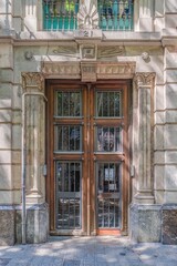 Obraz premium Classical Building Entrance, Wooden Door with Wrought Iron Grids, Decorative Stone Pillars, European Vintage Style Architecture