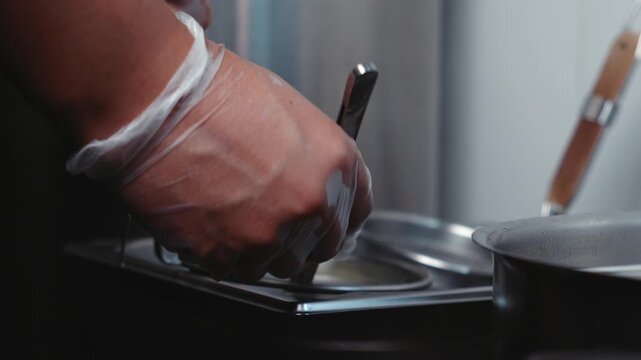 Mixing Noodles with Kitchen Tongs in a Cooking Basket Slow Motion