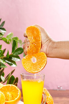 Fresh Orange Juice Squeezing Hand Citrus Fruit Healthy Drink Pink Background