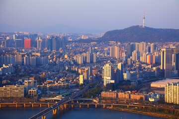 Obraz premium Seoul cityscape in South Korea. Sunset aerial view with Yongsangu district and Namsan hill.