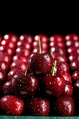 Fresh Red Cherries with Water Drops on Black Background © CungVan