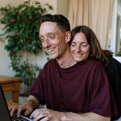 Fototapeta premium Affectionate couple using a laptop at home for remote work and cozy relationship background for web banner and lifestyle design