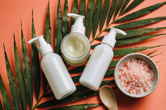 Natural Skincare Beauty Products on Tropical Palm Leaves Background