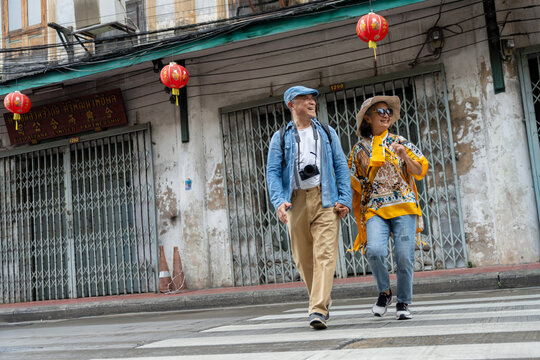 Happy Senior Asian Couple Sightseeing and Exploring Old Town Street