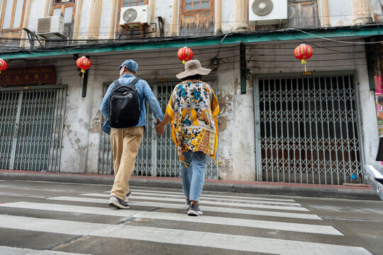Happy Senior Asian Couple Sightseeing and Exploring Old Town Street