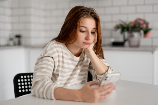 Thoughtful Teen Girl Dreaming At Home While Sitting At The Table