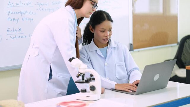 Science teacher explaining anatomy to students in classroom