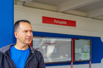 Fototapeta premium White European man in a blue shirt is landing at the Portugalete train station.