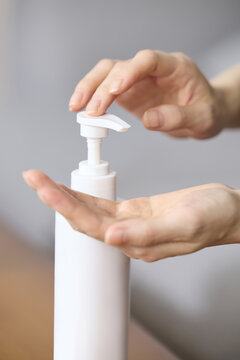 Hands Dispensing Soap from Pump Bottle for Hygiene
