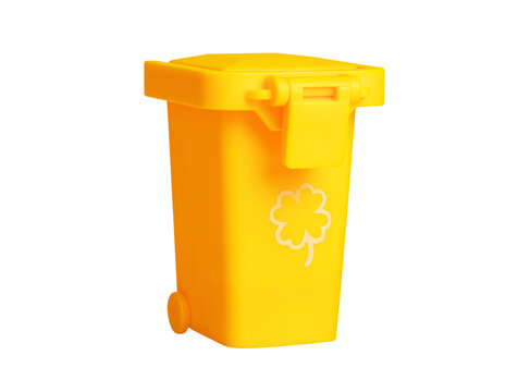 Bright yellow plastic recycling bin with shamrock motif, isolated on transparent background, ideal for eco-friendly and waste management concepts.