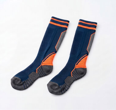 Pair of navy blue and orange compression trail running socks, breathable cushioned sports socks isolated on white background