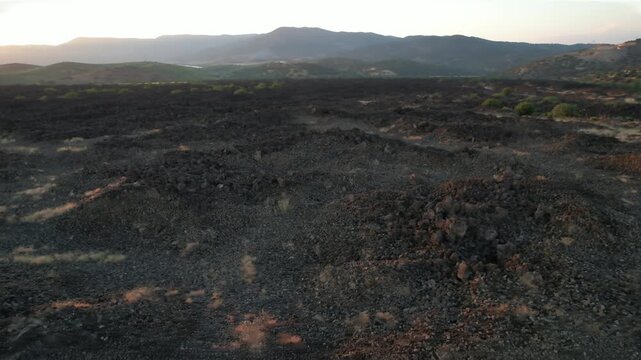 Close-up top-down view of dark volcanic soil and rocks from Kula Geopark in Turkey, fa01