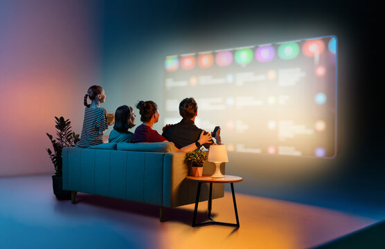 Family Enjoying Movie Night Together Streaming TV in Cozy Modern room
