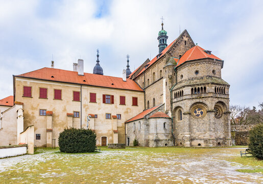 Exterior view of the Romanesque-Gothic St. Procopius Basilica and monastery castle under a cloudy sky in Trebic.