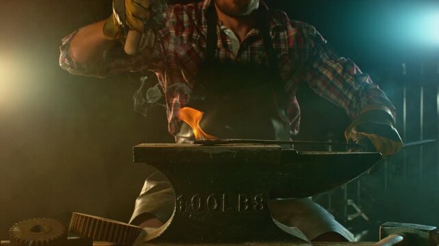 Cinematic close-up of blacksmith forging glowing hot iron on anvil with sparks flying. Shot in dramatic lighting on dark background with high-speed camera at 1000fps. Camera in motion.