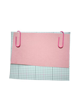 Pink note paper with two paper clips on grid pattern