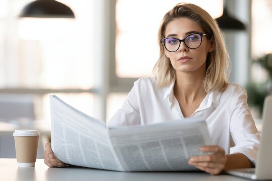 Professional Woman Reviewing Newspaper in Modern Office