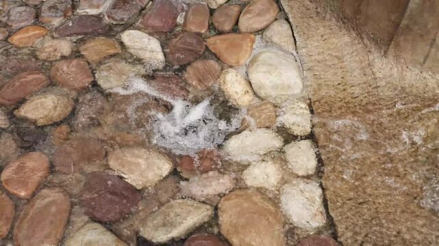 4K Close-up Overhead Flowing Water Bubbling Over Smooth River Stones Gentle Ripples Natural Zen Motion Background
