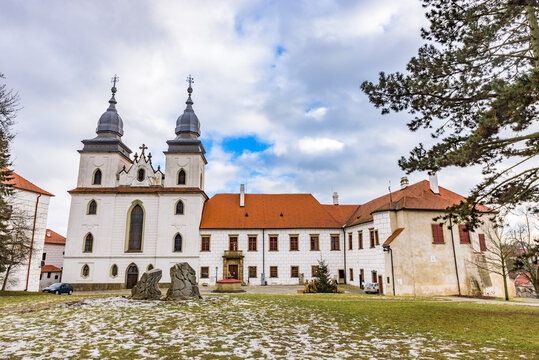 Exterior view of the Romanesque-Gothic St. Procopius Basilica and monastery castle under a cloudy sky in Trebic.