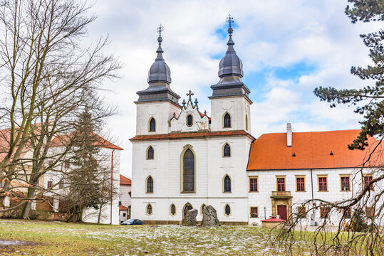 Exterior view of the Romanesque-Gothic St. Procopius Basilica and monastery castle under a cloudy sky in Trebic.