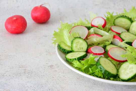 Fresh Salad with Radishes and Cucumber on Plate side view