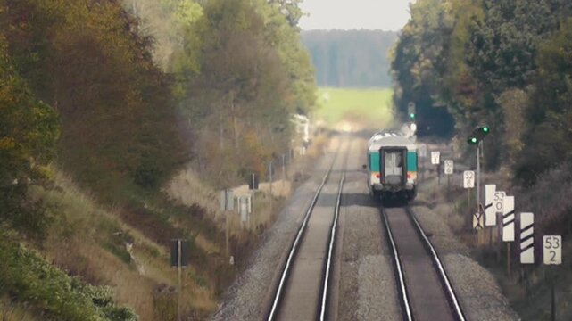 Passenger train passing through Bavarian countryside near Kaufering Kreisstrasse LL22