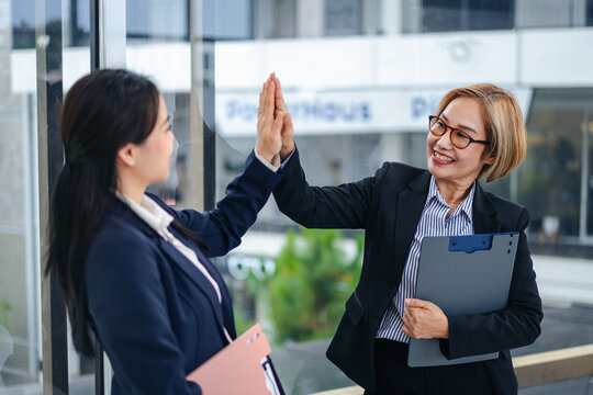 Business Women Celebrating Success with High Five Teamwork Achie