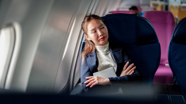 businesswoman sleeping comfortable airline seat long flight trav