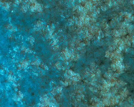 ​Horizontal abstract macro background featuring intricate blue and green mineral structures, crystal formations, and gemstone textures with shimmering light reflections.