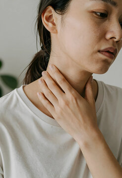 Worried woman checking lymph nodes on neck