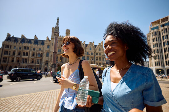 Two women stroll down a London street.