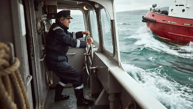 Maritime Officer Navigating Ship in Open Water During Daylight Cruise