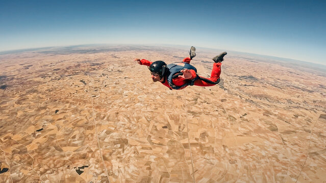 Skydiving above an expansive rural landscape