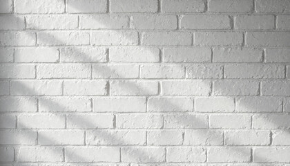 Fototapeta premium White brick wall background with soft morning sunlight casting diagonal shadows.