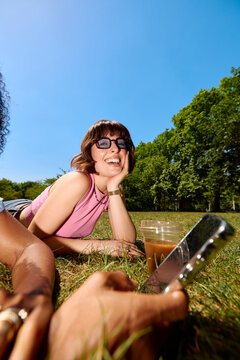 Happy woman spends time with her friend in a park
