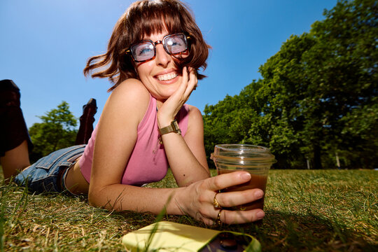 Woman enjoys her free time relaxing on a lawn