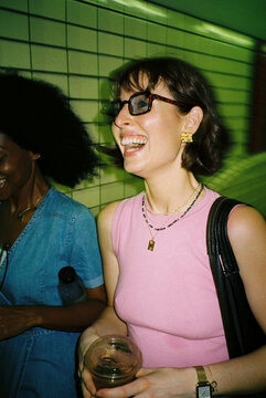 Happy women walk through the subway hallway