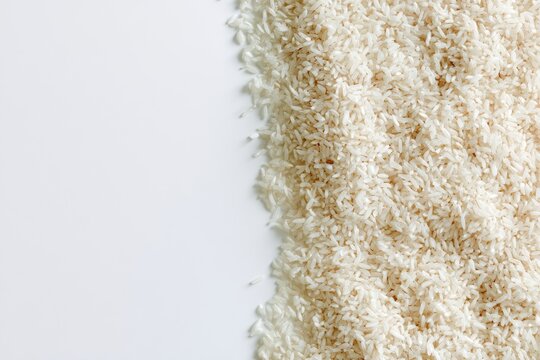 A pile of uncooked white grains on a white surface