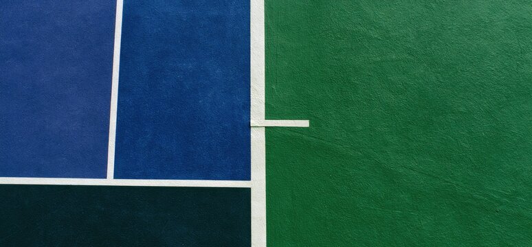 Aerial view of a blue and green court with white lines