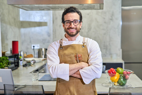 Male chef smiling in professional home kitchen