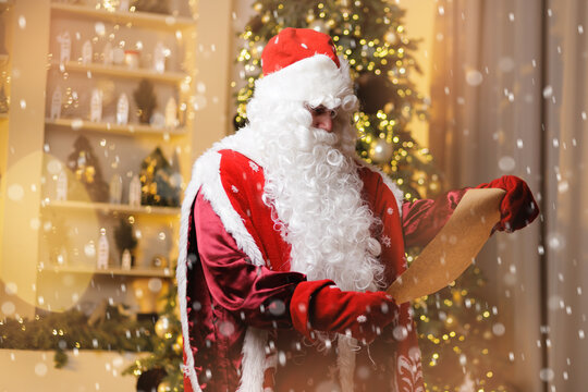 Happy Santa Claus Russian in festive attire reading letter on craft paper scroll in holiday setting