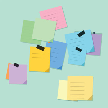 Assorted adhesive note pads on light background with sticky notes post it reminder stationary
