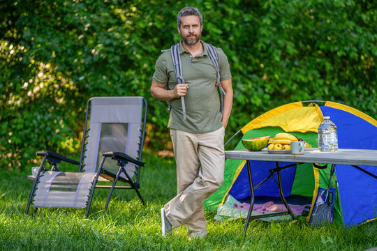 Camp adventure. Hiking lifestyle. Man at campsite. Picnic time. Man at camp picnic in forest. Man hiking on summer day. Summer camp activity. Summer camping retreat. Time to relax