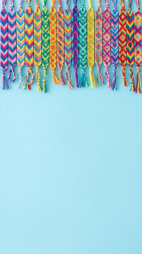 Multicolored Friendship Bracelets Arranged in a Row on Light Blue Background