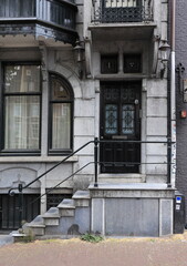 Fototapeta premium Art Nouveau Canal House Facade Detail with Door and Entrance Steps in Amsterdam, Netherlands