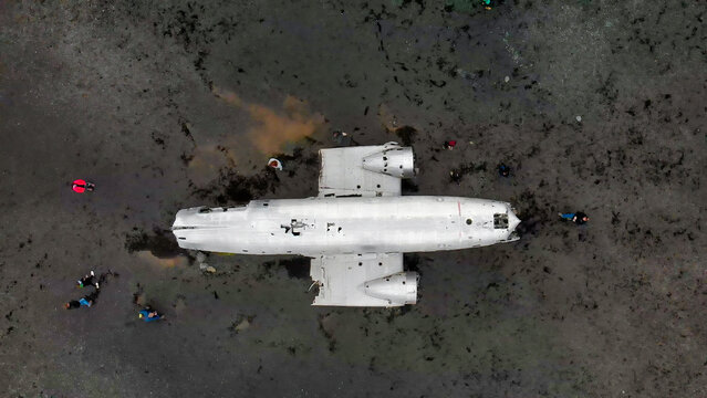 Drone panorama of airplane wreck on Iceland's remote coastline.
