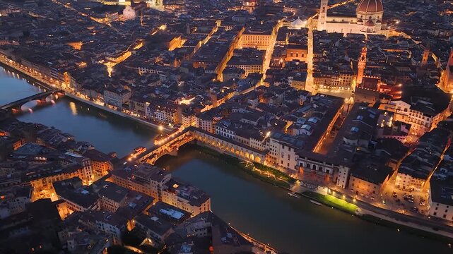 Florence, Italy. Aerial night 4K panoramic drone view of the city at dusk. Majestic view of the ancient city skyline with Basilics, Palazzo Vecchio, bridges, iconic buildings. Europe from above.