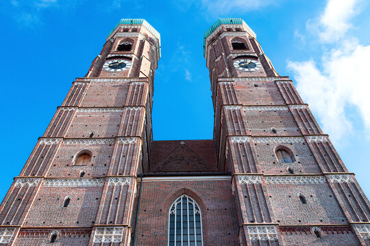 A view of the Frauenkirche's tall towers in Munich, looking towards the sky.