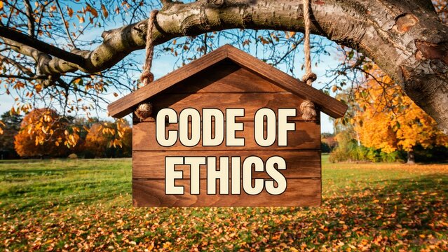 Code of ethics text on a hanging wooden sign in an autumn park