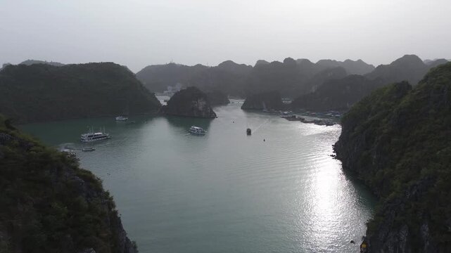 Breathtaking aerial footage flying over the emerald waters of halong bay and its limestone islands